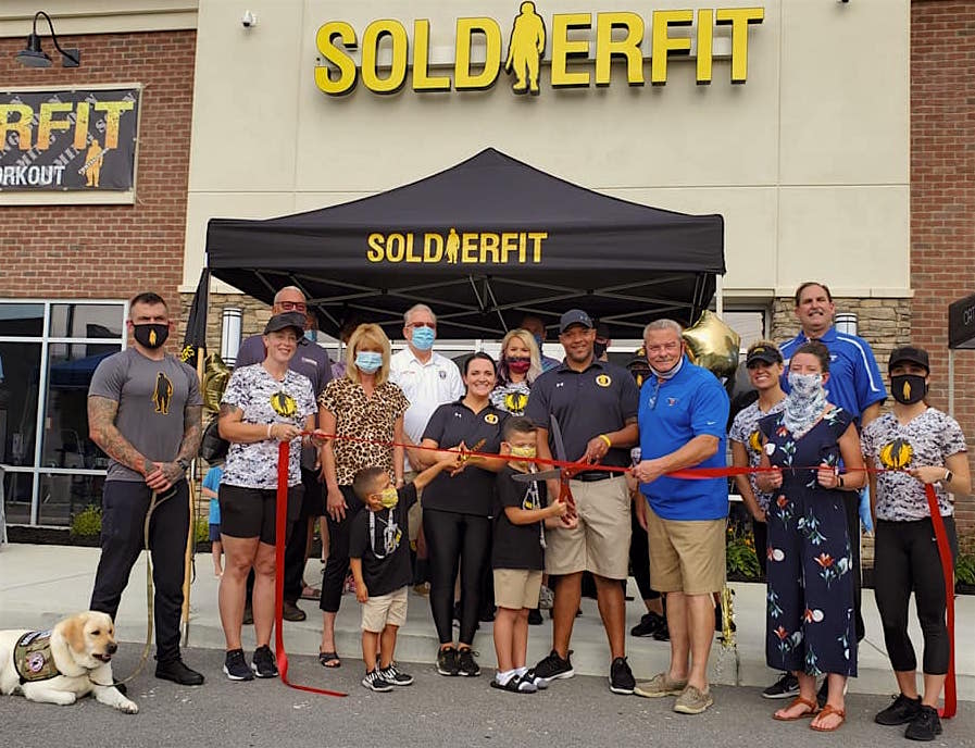 photograph of a ribbon cutting ceremony outside Soldierfit